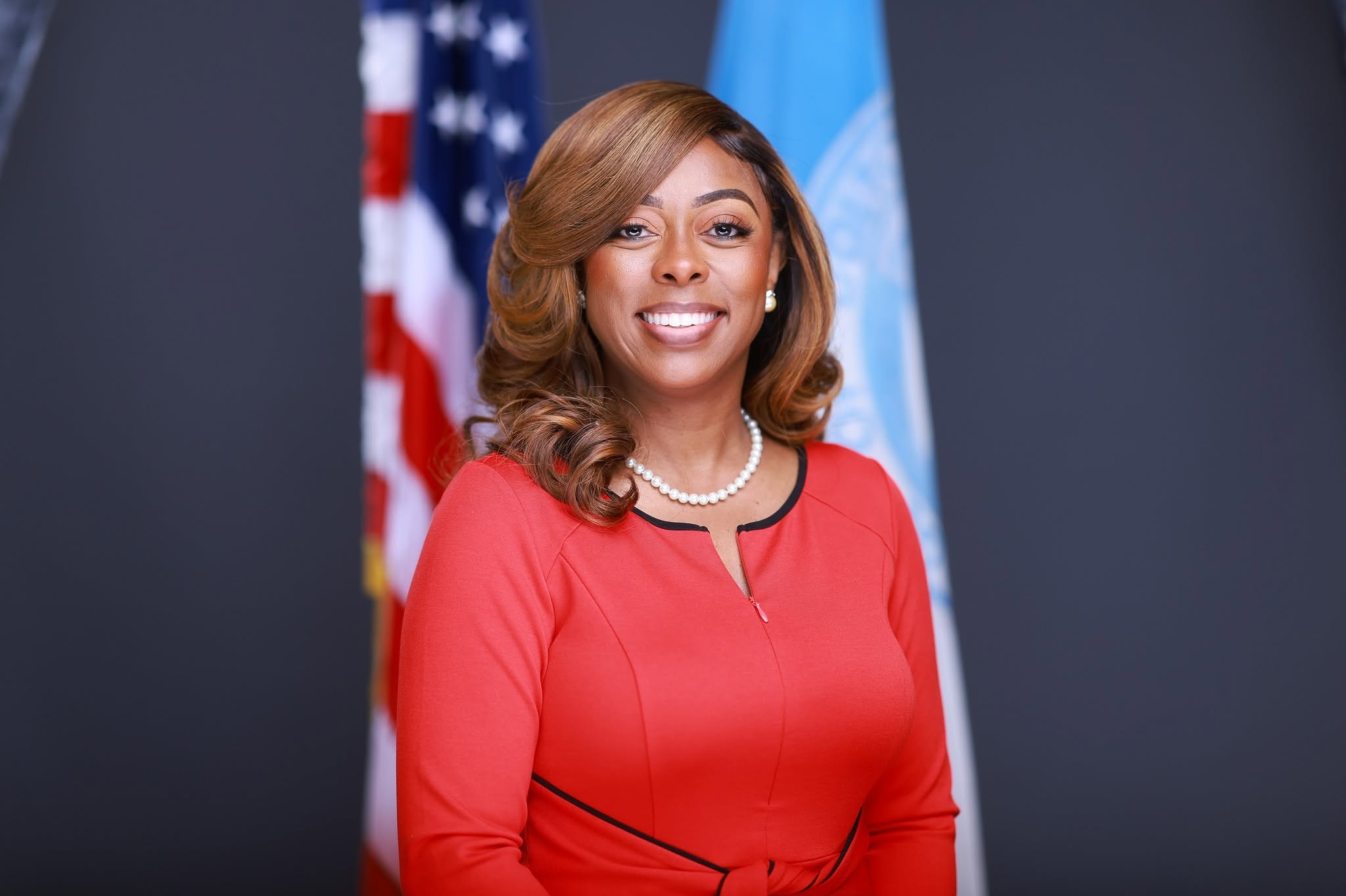 Tiffany A. Henyard in front of the American flag